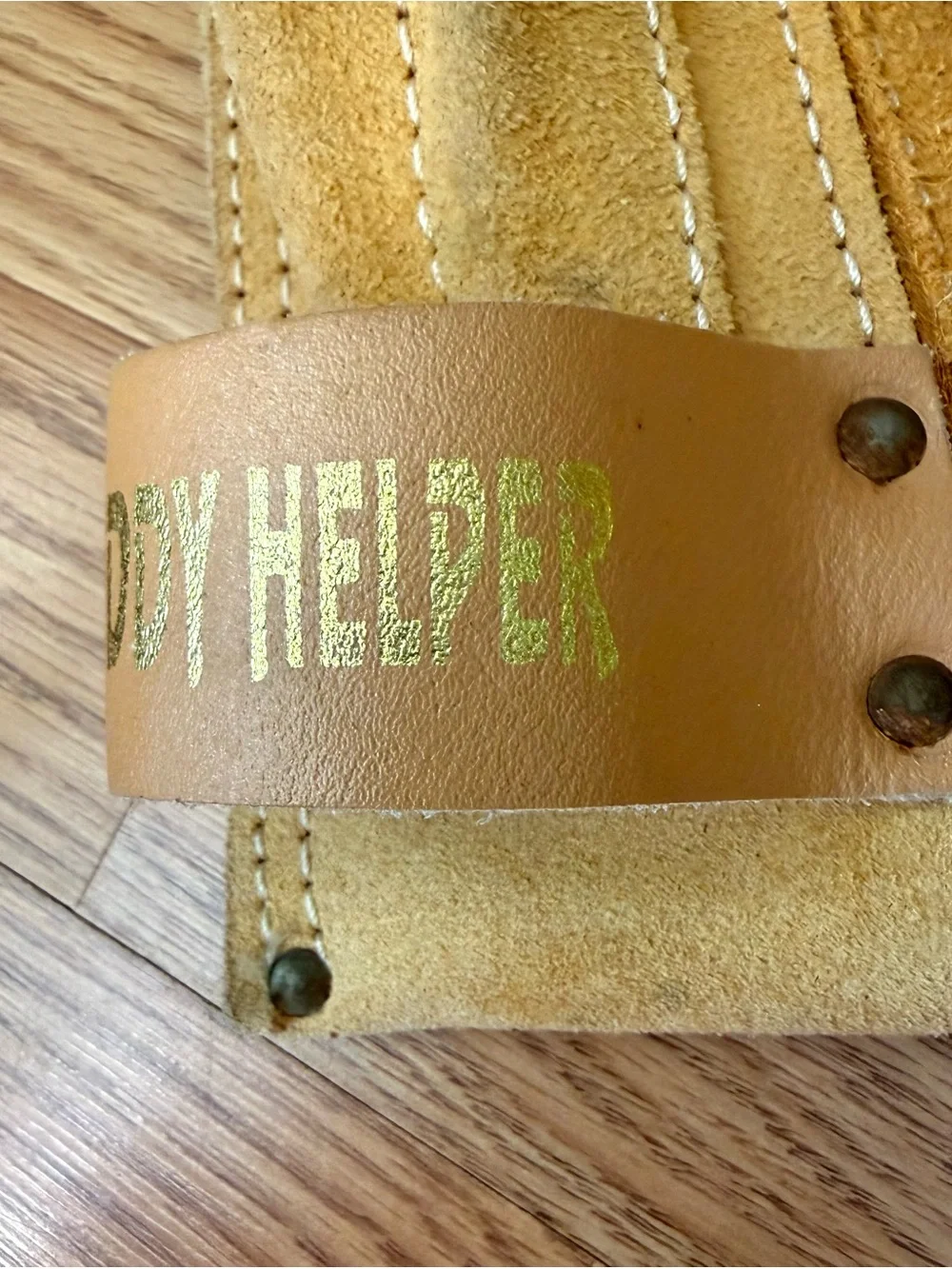 Suede leather Tool-belt that says ”Daddy Helper”n large gold letters in front.
